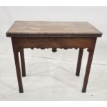 George III mahogany concertina-action card table, the rectangular top with carved border, hinged