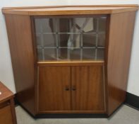 Mid-century corner unit with two sliding glass doors above two cupboard doors, plinth base