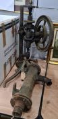 Old hand-cranked pillar drill and a cast iron water pump