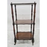 Victorian rosewood three-tier whatnot, the shaped tier supported by ring turned circular uprights,