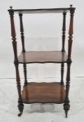 Victorian rosewood three-tier whatnot, the shaped tier supported by ring turned circular uprights,