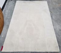 A modern cream ground rug with stylised rectangular design.  Measurements: 238 x 156cm;