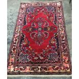 Iranian wool rug, red ground, foliate decoration in pink, yellow and blue, cream border with foliate