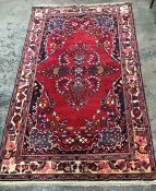 Iranian wool rug, red ground, foliate decoration in pink, yellow and blue, cream border with foliate