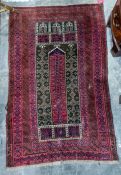 A Persian rug, red ground with cream blue and white design and multi border. Measurements 138/87cm