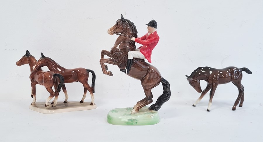 Beswick pottery glazed huntsman on horseback and two pottery model horses with brown glaze (3)