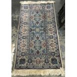Turkish wool rug, the ivory ground with light blue rectangle to centre with allover medallions and