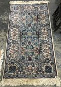 Turkish wool rug, the ivory ground with light blue rectangle to centre with allover medallions and