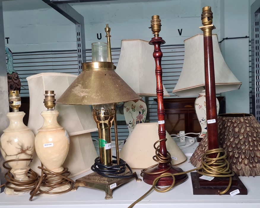 Various table lamps to include two wooden table lamps, brass paraffin lamp converted to