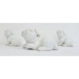 Three various Japanese Meiji period Hirado white glazed porcelain models of Akita puppies, each