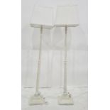 Pair of cream painted and fluted standard lamps on square bases with white pleated shades (2)