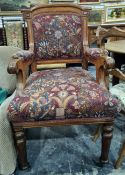 Late Victorian oak-framed armchair with upholstered seat, back and arm rests, on turned and fluted