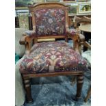 Late Victorian oak-framed armchair with upholstered seat, back and arm rests, on turned and fluted