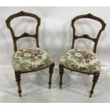 Set of four late 19th century dining chairs with carved top rail and stuffover seats, on turned