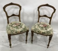 Set of four late 19th century dining chairs with carved top rail and stuffover seats, on turned