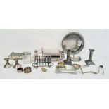 Pair of plated candlesticks, toast rack, tea strainer and other plated ware