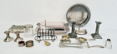 Pair of plated candlesticks, toast rack, tea strainer and other plated ware