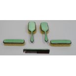 Early 20th century silver and enamel dressing table set comprising three brushes and a