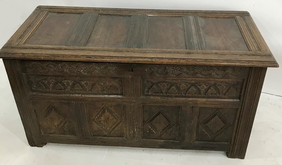 18th century and later blanket chest with four-panelled top, carved front panels and fluted front