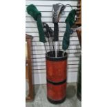 Quantity various golf clubs in red and black painted metal stickstand