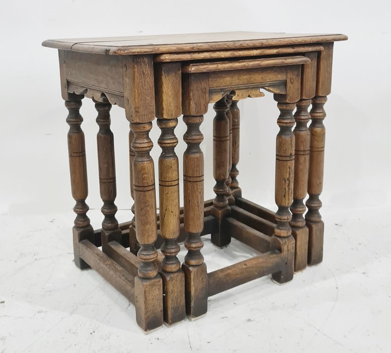 20th century oak nest of three tables on turned and block supports, stretchered base