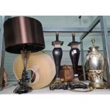 Pair of Egyptian-style painted wood table lamps, black with gilt gadrooning, on square stepped base,