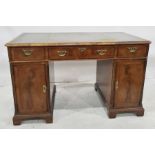 Victorian, Georgian-style mahogany pedestal desk, the rectangular top with canted corners and