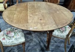 19th century mahogany drop-leaf oval table on cylindrical tapering supports to pad feet, 134cm x