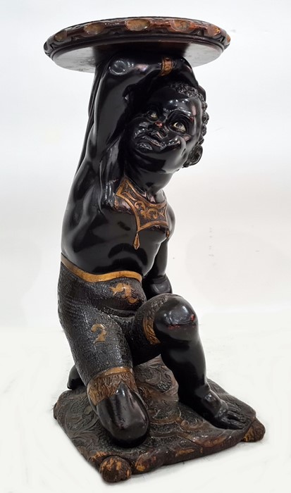 Early 19th century painted and ebonised torchere in the form of kneeling figure, holding aloft a