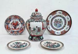 20th century Oriental lidded vase in black, green and red, two Oriental plates and two Oriental-