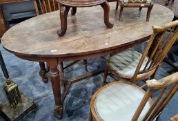 Late 19th/early 20th century oak oval plank-top table on turned and block supports, stretchered