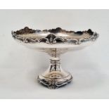 1920's silver circular pedestal dish with relief decoration to rim, on turned support and circular