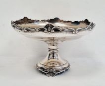 1920's silver circular pedestal dish with relief decoration to rim, on turned support and circular