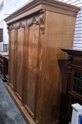 19th century mahogany compactum wardrobe with moulded cornice above three doors, plinth base, two