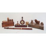 Carved wooden inkwell in the form of a cat with glass eyes, various wooden eggcups, a desk tidy with