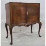 20th century walnut and banded cocktail cabinet, the rectangular top with canted corners above two