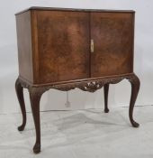 20th century walnut and banded cocktail cabinet, the rectangular top with canted corners above two