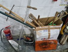 Box of various gardening tools including scythe, shovels and a bow saw, a small quantity of spanners