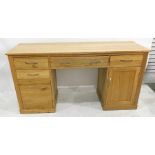 Modern oak desk, the rectangular top above pull-out keyboard drawer flanked by filing drawers and