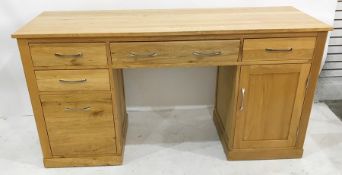 Modern oak desk, the rectangular top above pull-out keyboard drawer flanked by filing drawers and