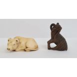 Japanese carved ivory netsuke in the form of a seated bullock, 5cm long and a Japanese carved wood