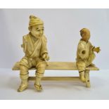Late 19th century Japanese carved ivory group of two figures seated on bench (each figure with