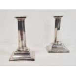 Pair of early 20th century silver-mounted candlestick holders with beaded rim, octagonal tapered