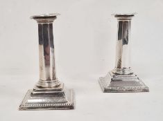 Pair of early 20th century silver-mounted candlestick holders with beaded rim, octagonal tapered