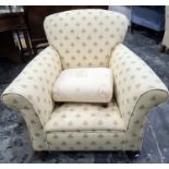 Early 20th century armchair in a cream ground foliate upholstery and a low stool (2)
