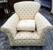 Early 20th century armchair in a cream ground foliate upholstery and a low stool (2)