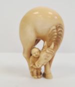 Japanese carved ivory netsuke, early Edo period, in the form of a horse bending down towards