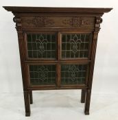 Early 20th century Arts & Crafts-style cabinet in oak, the moulded cornice above the applied