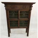 Early 20th century Arts & Crafts-style cabinet in oak, the moulded cornice above the applied