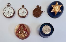 Three acrylic paperweights, each set with a medals; one 1939-45 medal, one 1939-45 star and 1914-